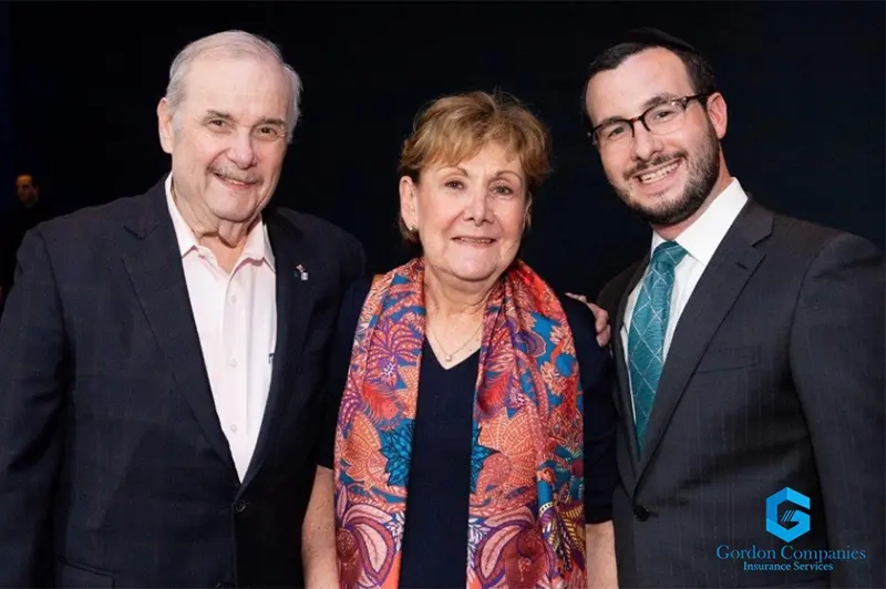 Founder David Gordon smiling alongside his wife Goldie and his son Aaron